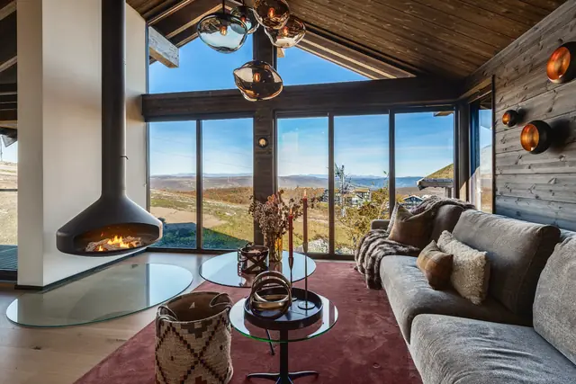 Living room with suspended fireplace and panoramic windows
